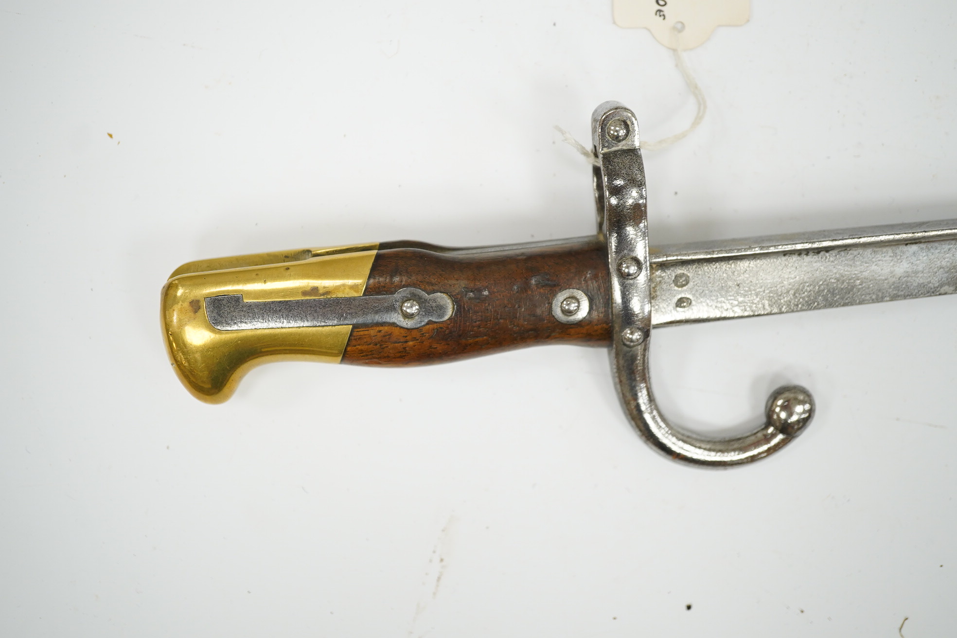 Two French Gras bayonets; a bayonet with a T-section blade dated 1877, and another almost identical blade dated 1879, scabbards missing. Condition - good